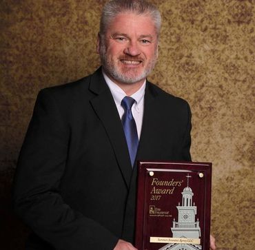 Insurance agent holding plaque