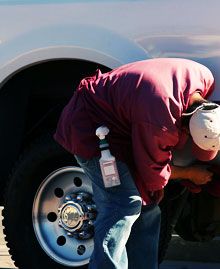 Man checking auto tire
