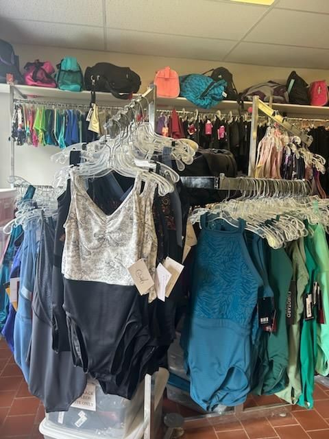 A store filled with lots of clothes hanging on racks.