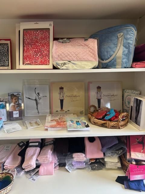A shelf filled with a variety of items including socks and a basket.