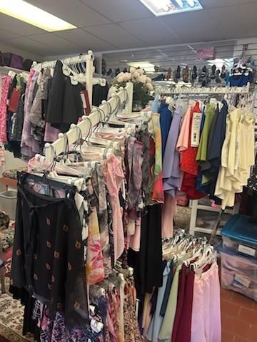 A store filled with lots of clothes hanging on racks.