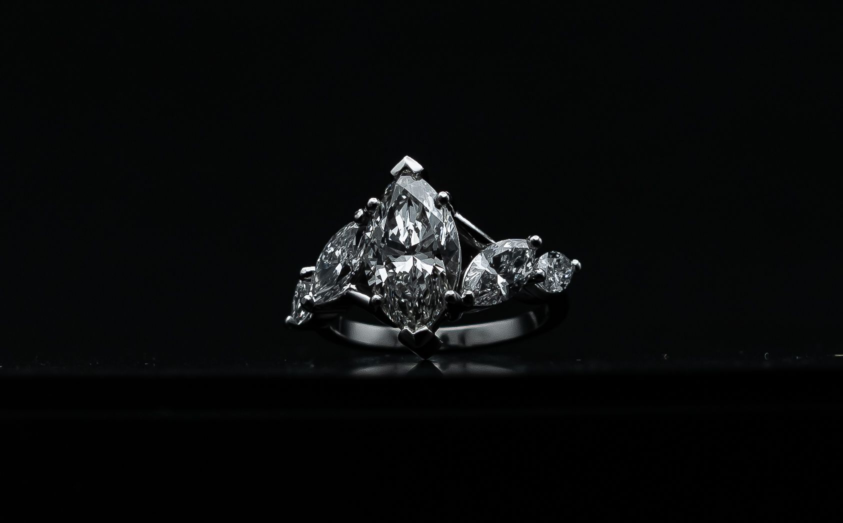 Two sparkling diamond rings on a black background