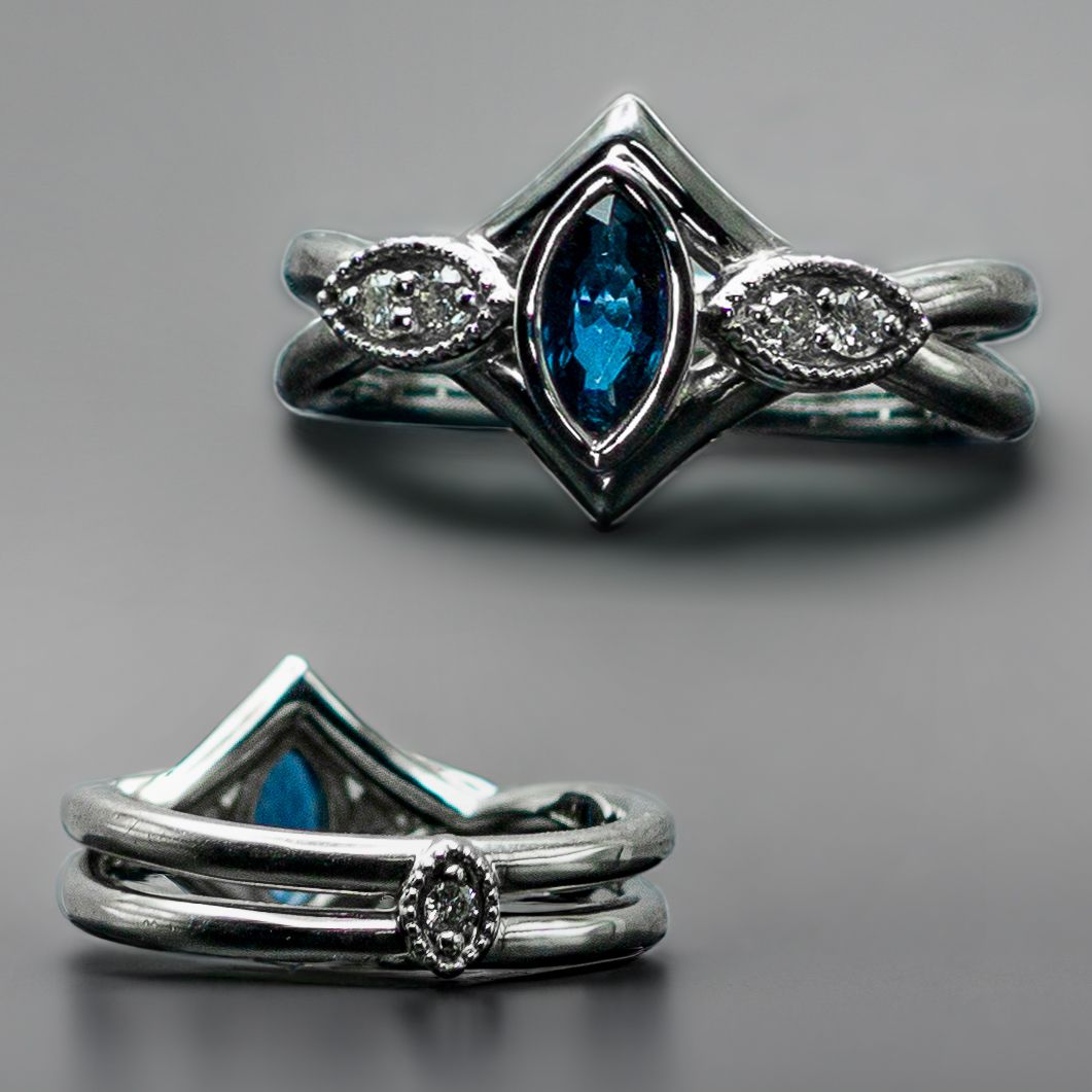 Blue gemstone ring shown from front and side on a gray background