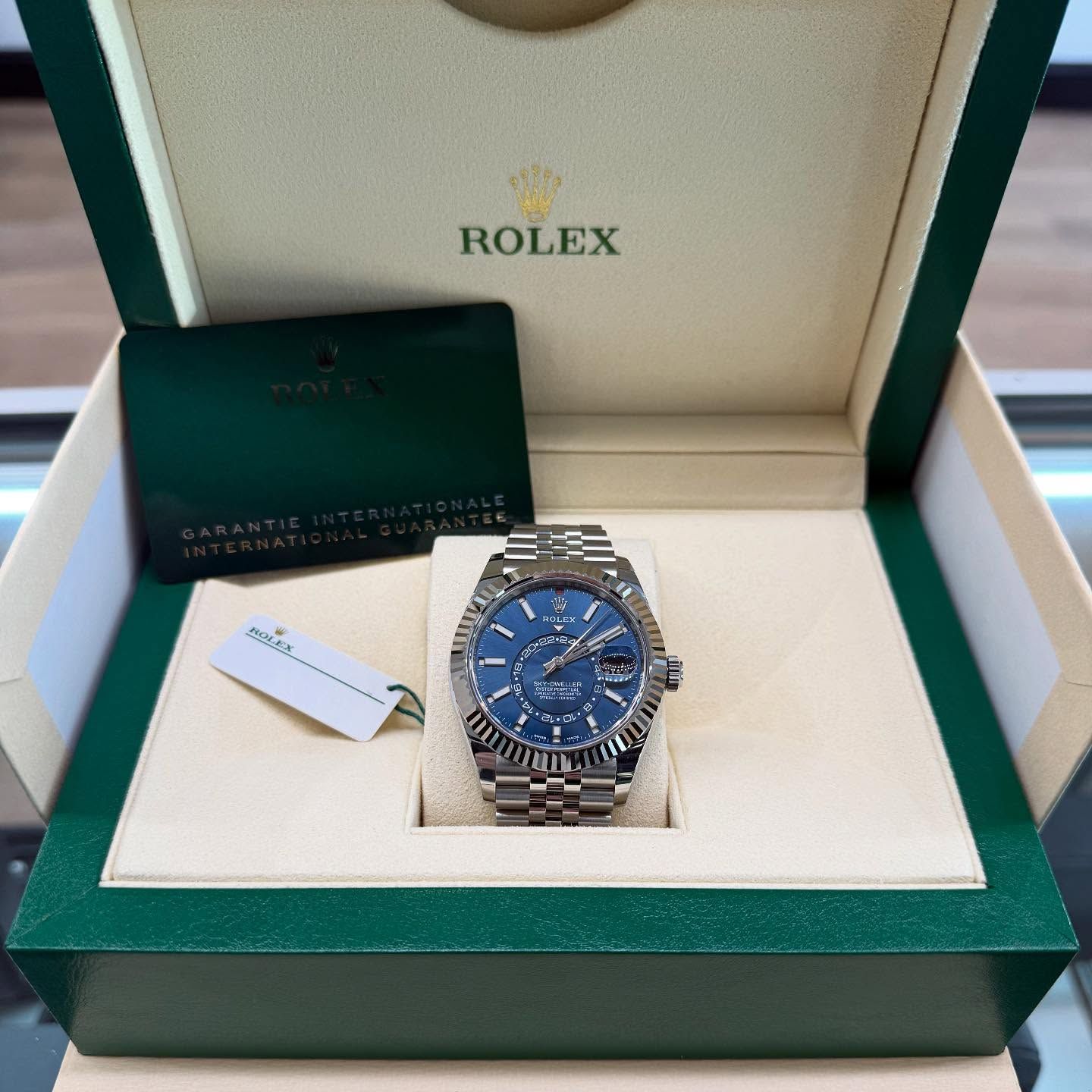 Rolex watch with blue dial in open presentation box