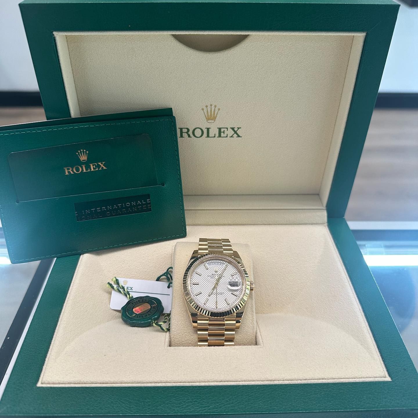 Rolex watch in teal presentation box with warranty card and tag