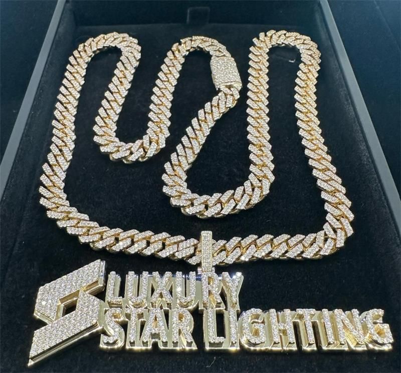 Gold chain and diamond pendant reading “Luxury Star Lighting” in a black display box