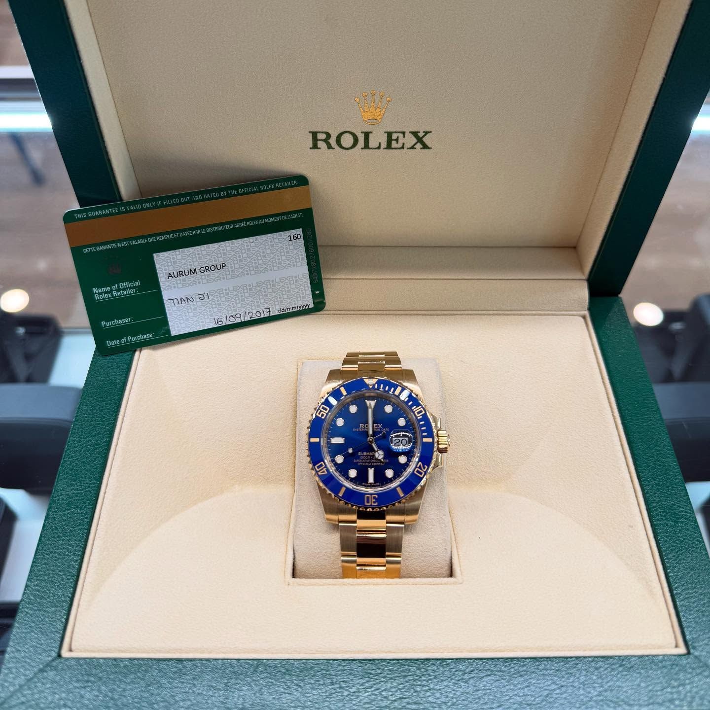 Rolex watch with blue dial in an open cream display box