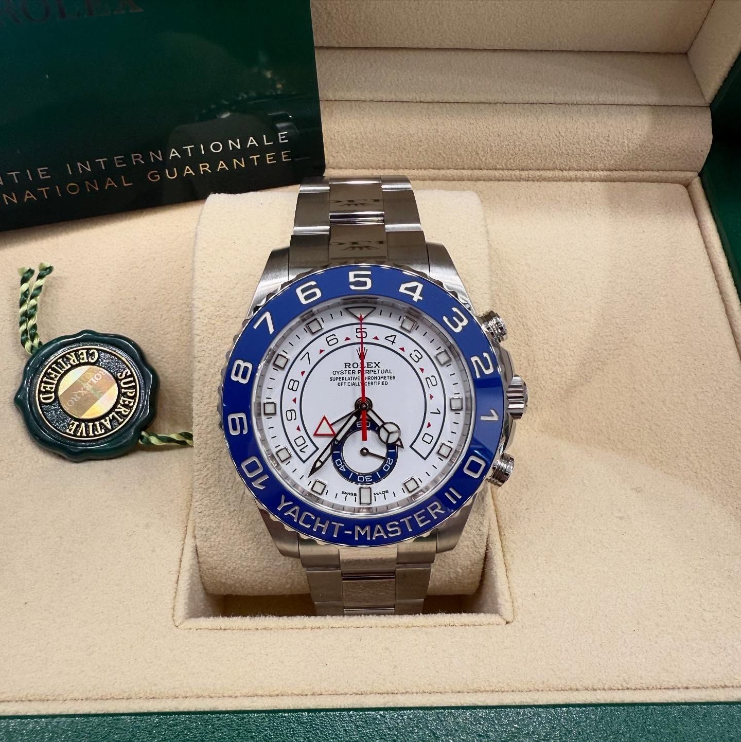 Rolex Yacht-Master watch in a green presentation box with warranty card and tag.