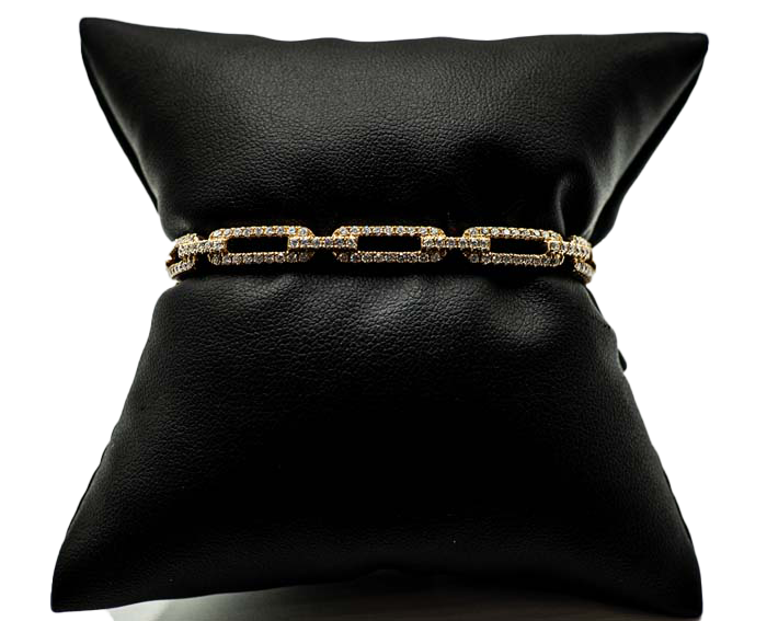 Black leather cushion with a gold chain band around the middle