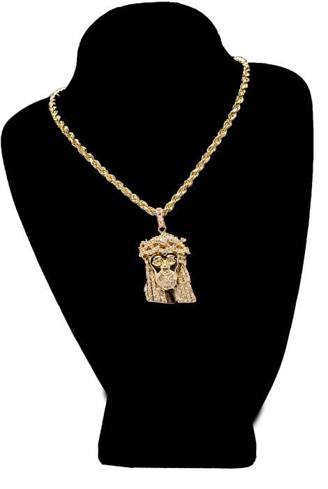 Gold chain necklace with ornate pendant displayed on a black mannequin bust