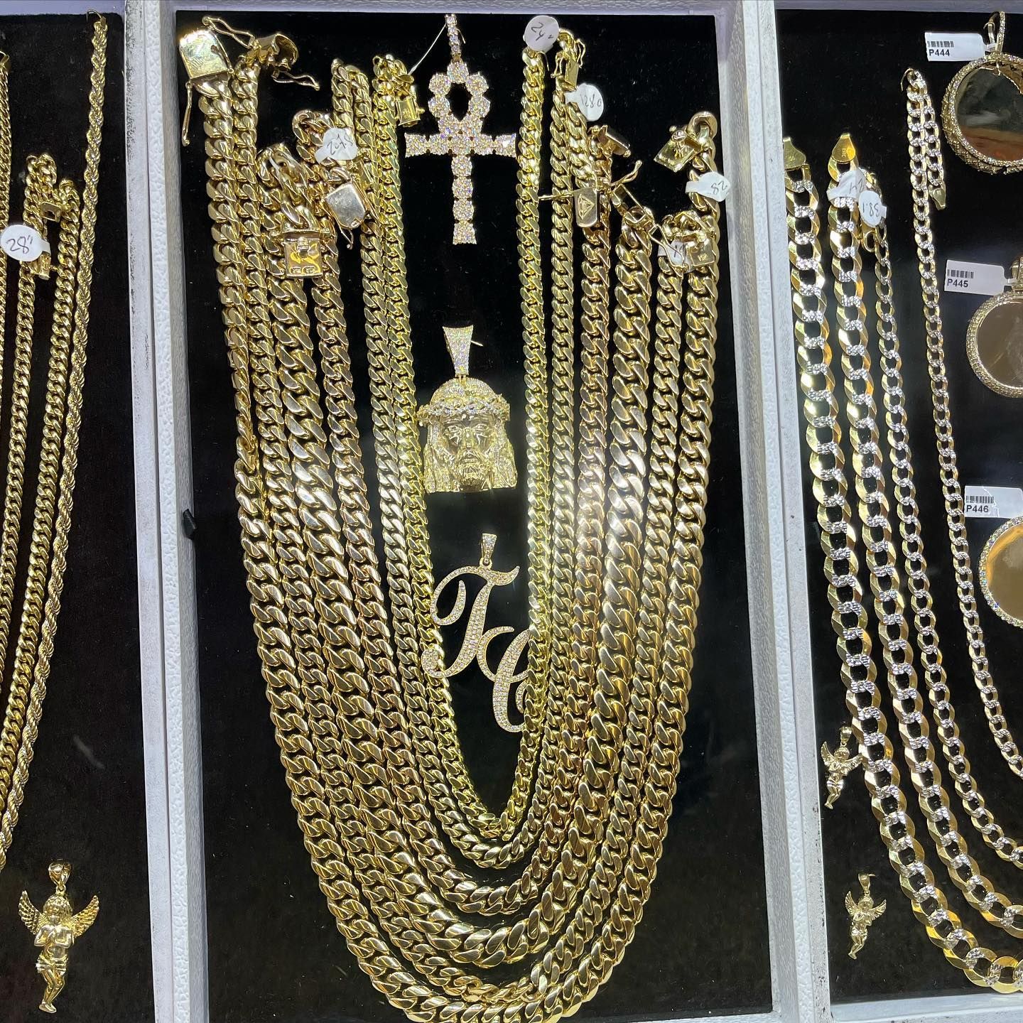 Gold necklaces and pendants displayed on black velvet in a jewelry shop case