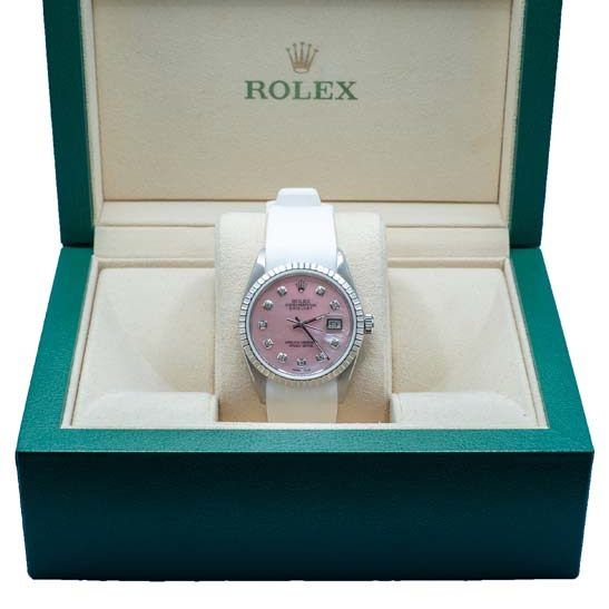 Rolex watch with pink face in a green presentation box