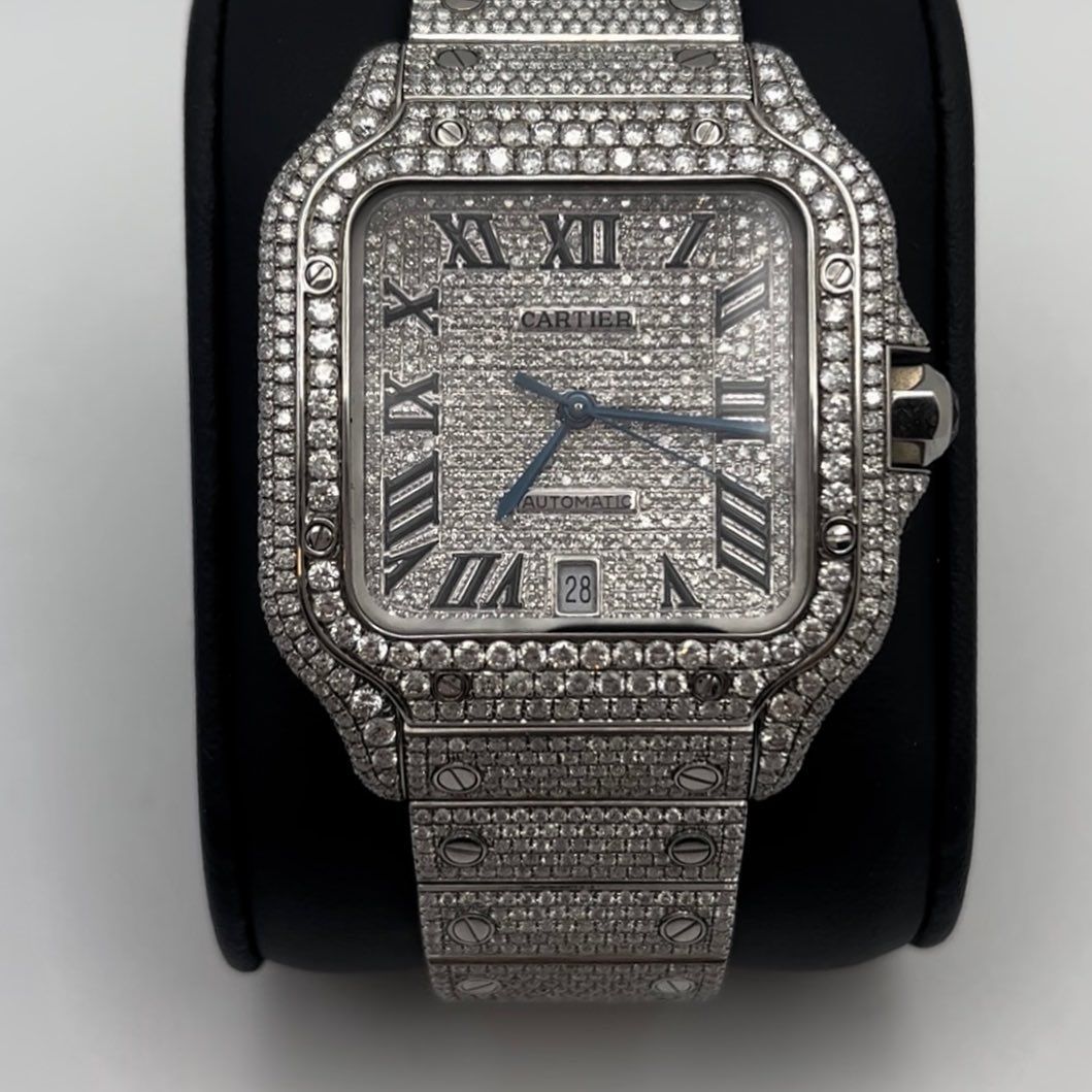 Diamond-encrusted silver wristwatch with Roman numerals on a black display stand