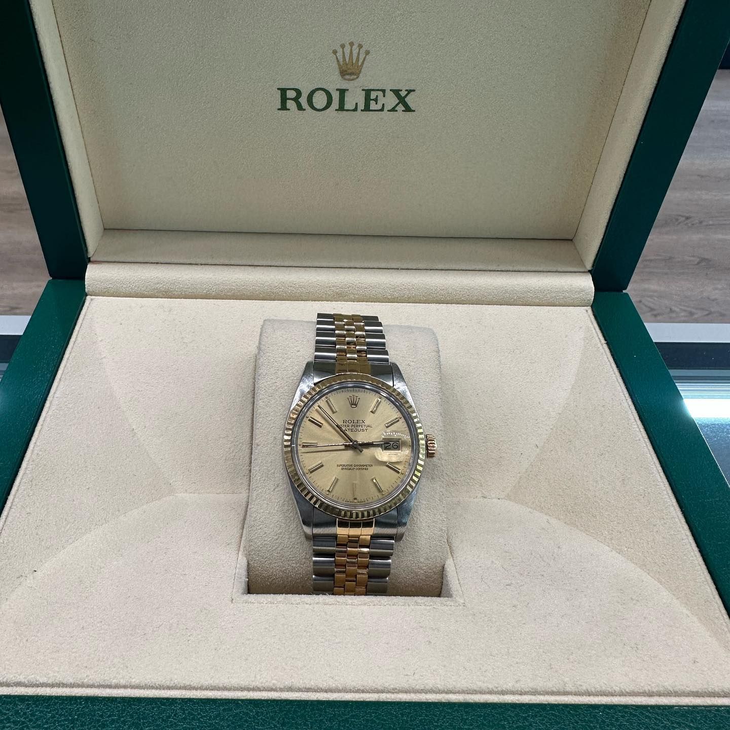 Rolex watch with two-tone bracelet displayed in an open presentation box