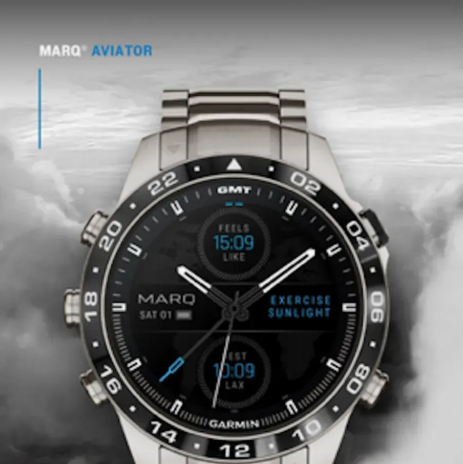 Garmin MARQ Aviator smartwatch with black dial and stainless steel band, showing flight-style digital displays