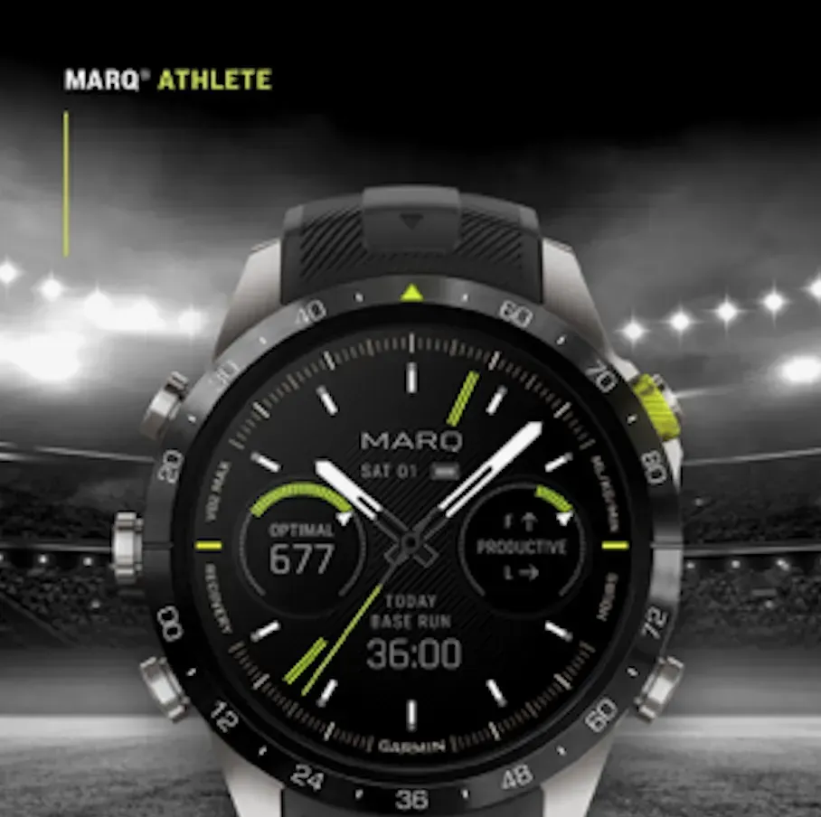 MARQ Athlete Garmin smartwatch on a stadium background, showing training metrics and black-green dial