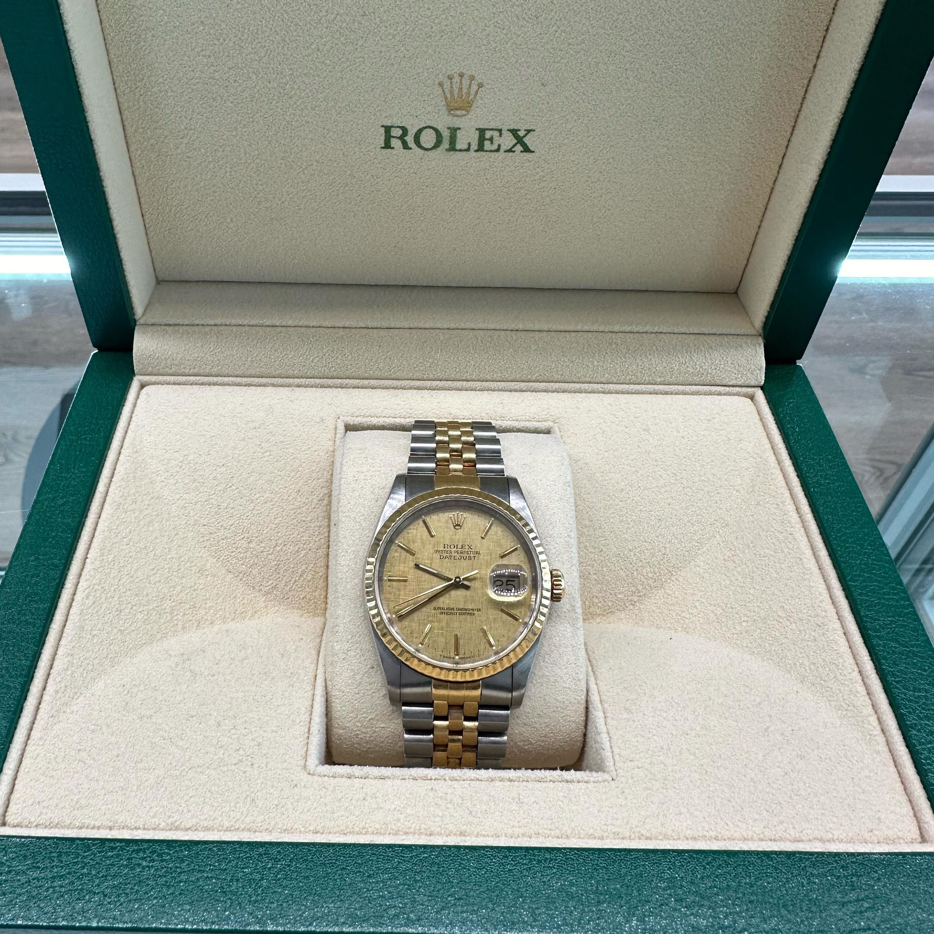 Rolex watch in a green presentation box, gold and silver two-tone bracelet, gold dial