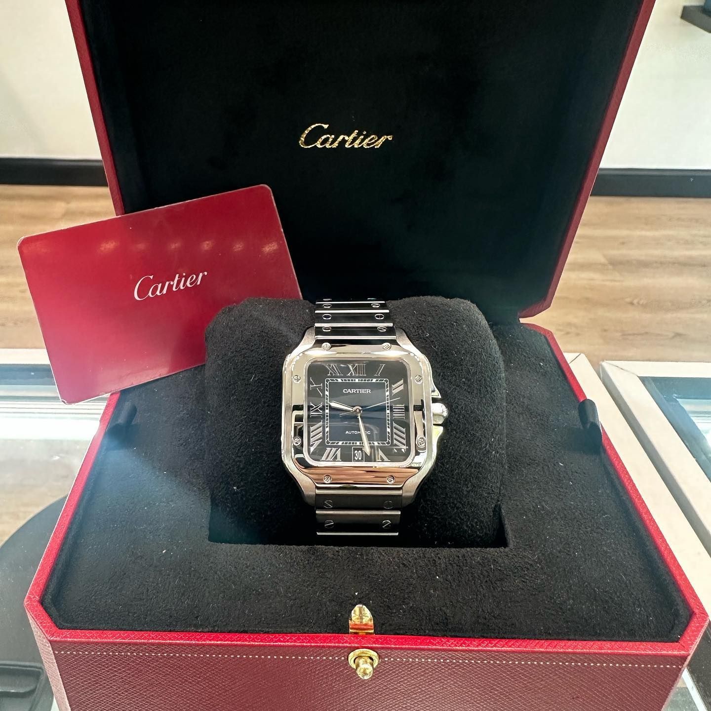 Cartier wristwatch in a red presentation box with warranty card