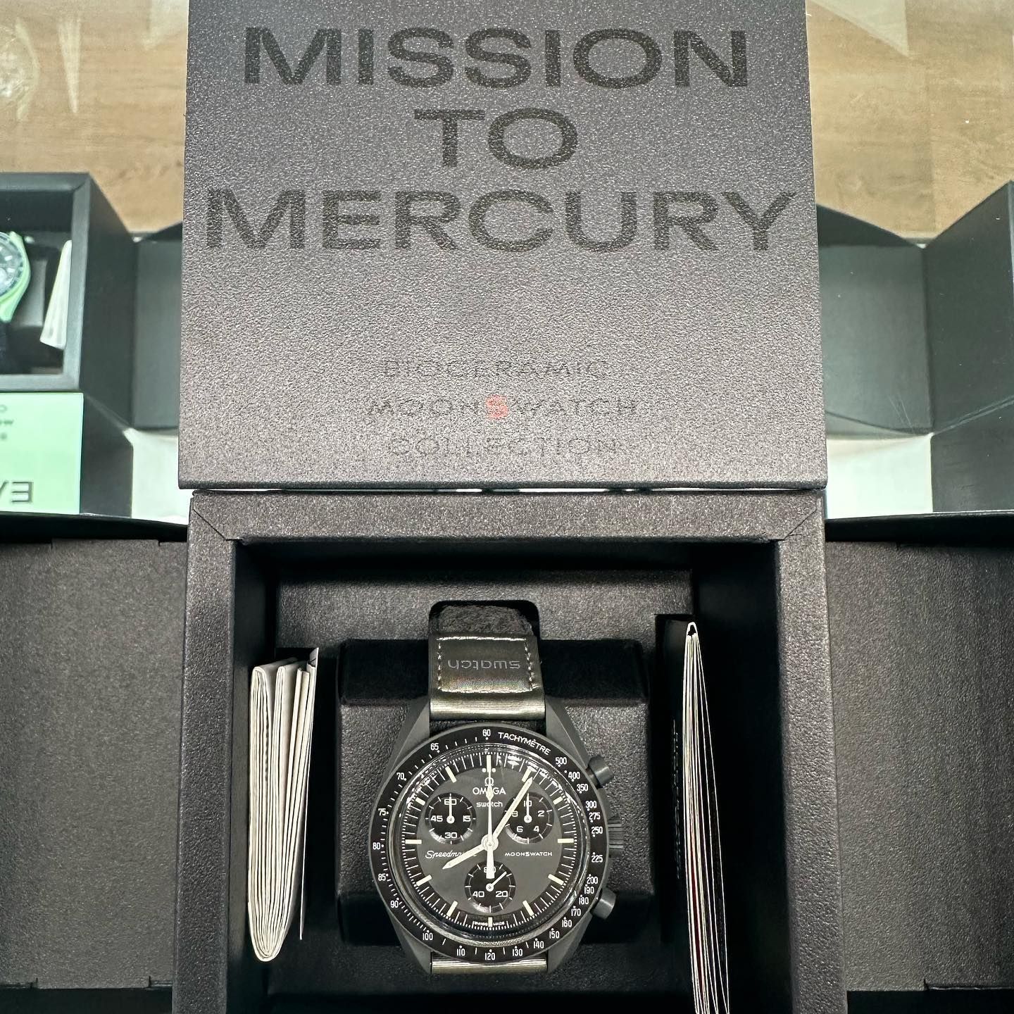 Watch in black box labeled “Mission to Mercury” with a black strap and accessories.
