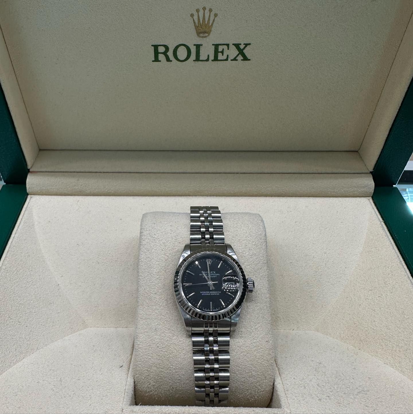 Rolex wristwatch in a presentation box, black dial and silver metal bracelet