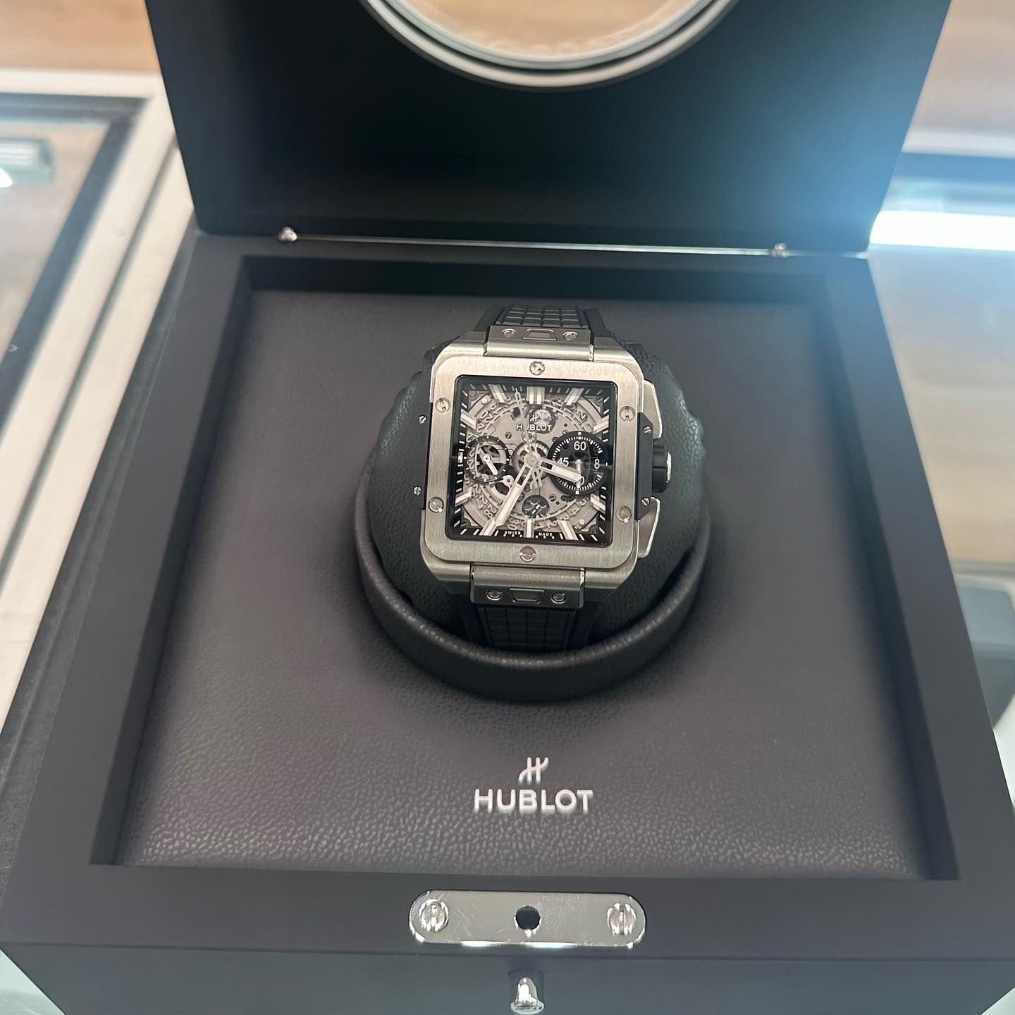 Hublot luxury watch displayed in a black presentation box on a store counter