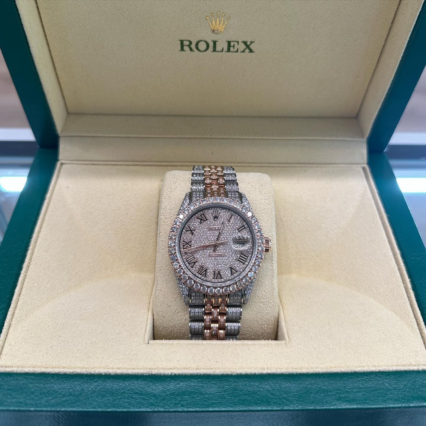 Rolex watch in a teal and cream display box