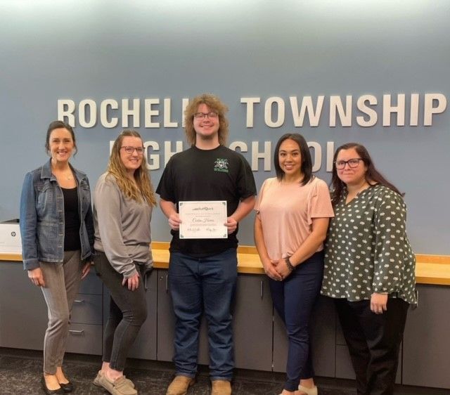 Five people stand in front of