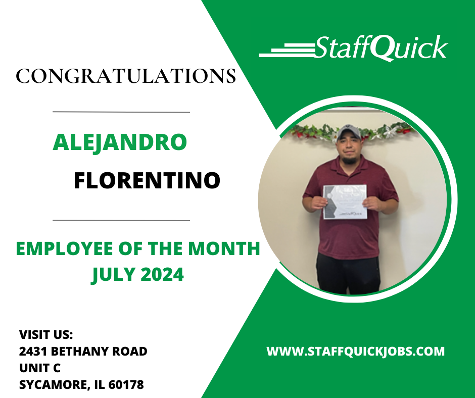 A man is standing in front of a wall holding a certificate.