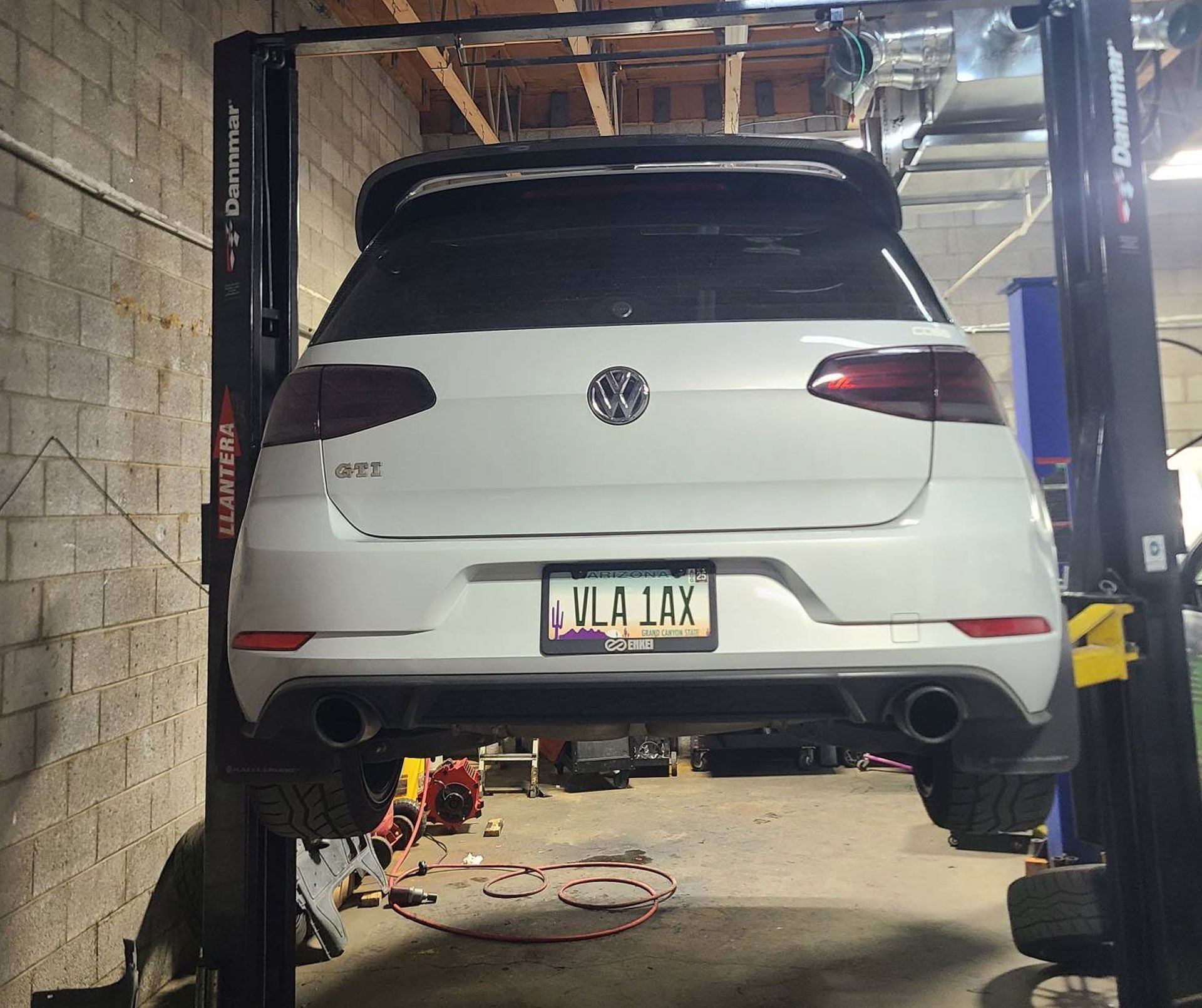 A white car with a license plate