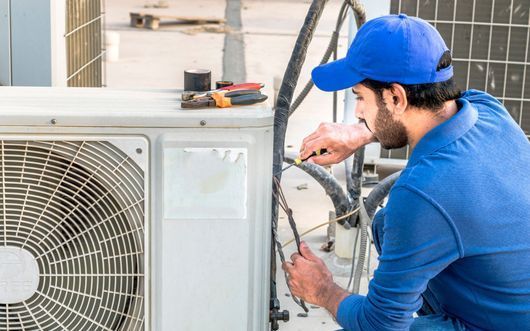 man fixing air conditioning