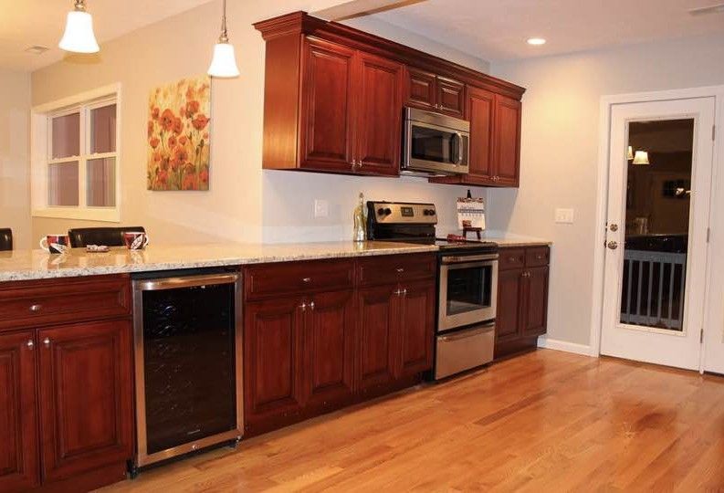 Kitchen with cherry cabinets, stainless steel appliances, and hardwood floors.