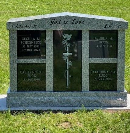 A stone columbarium monument with the text 