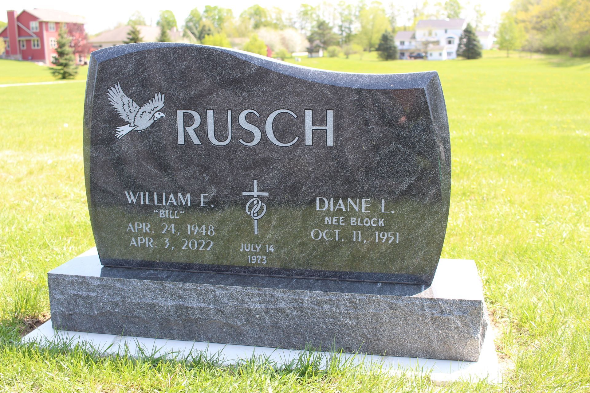A black granite headstone with the name 