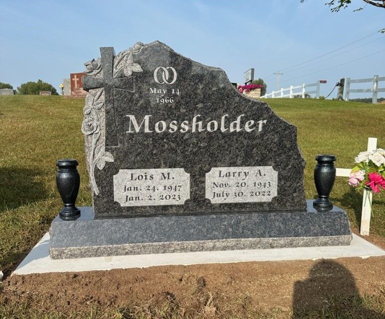 A gravestone in a cemetery with a name on it