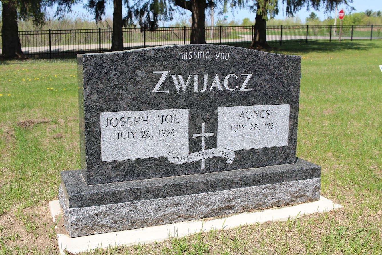 A gravestone in a cemetery - gray