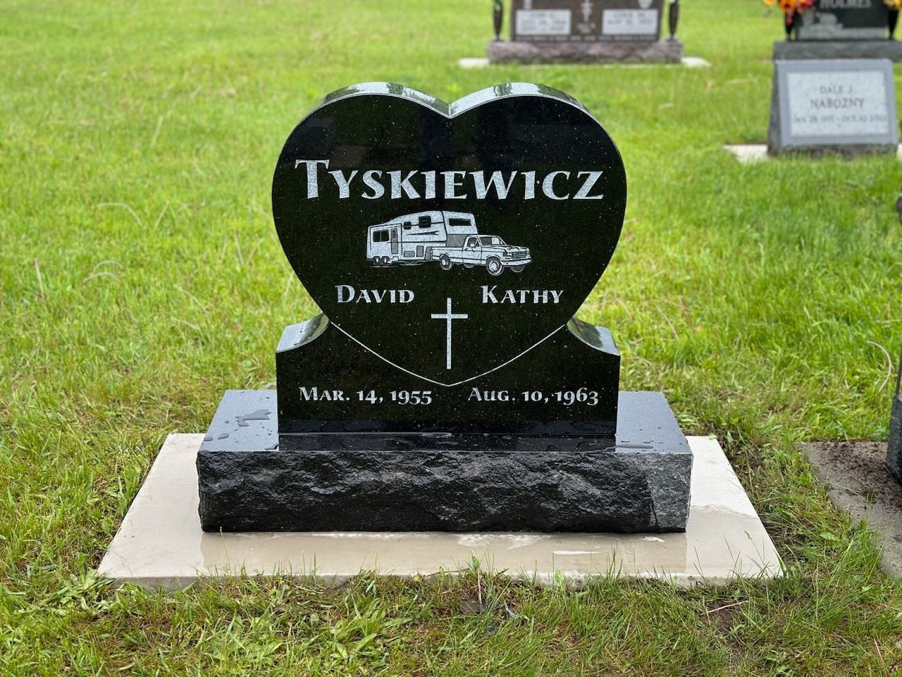 A black heart shaped gravestone