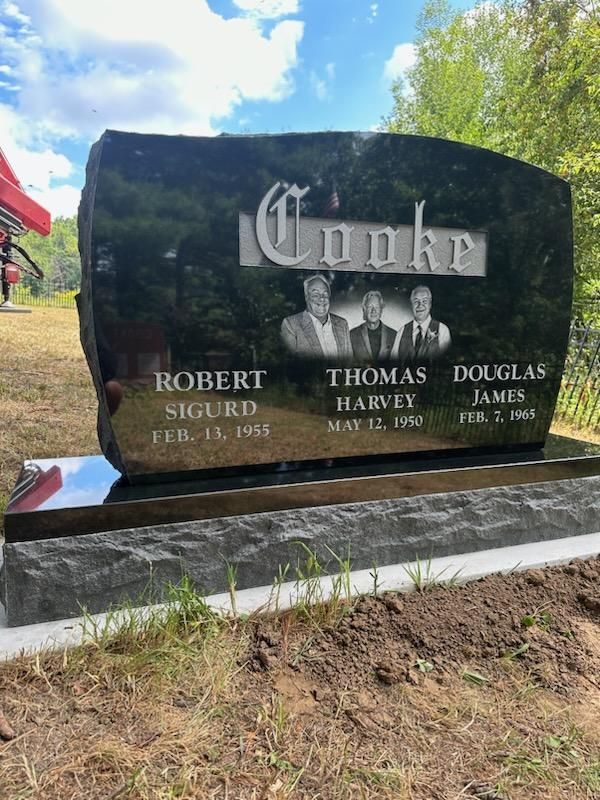 A gravestone for robert sigurd and douglas james in a cemetery.