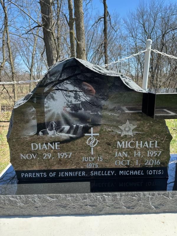 A gravestone for diane and michael is in a cemetery.