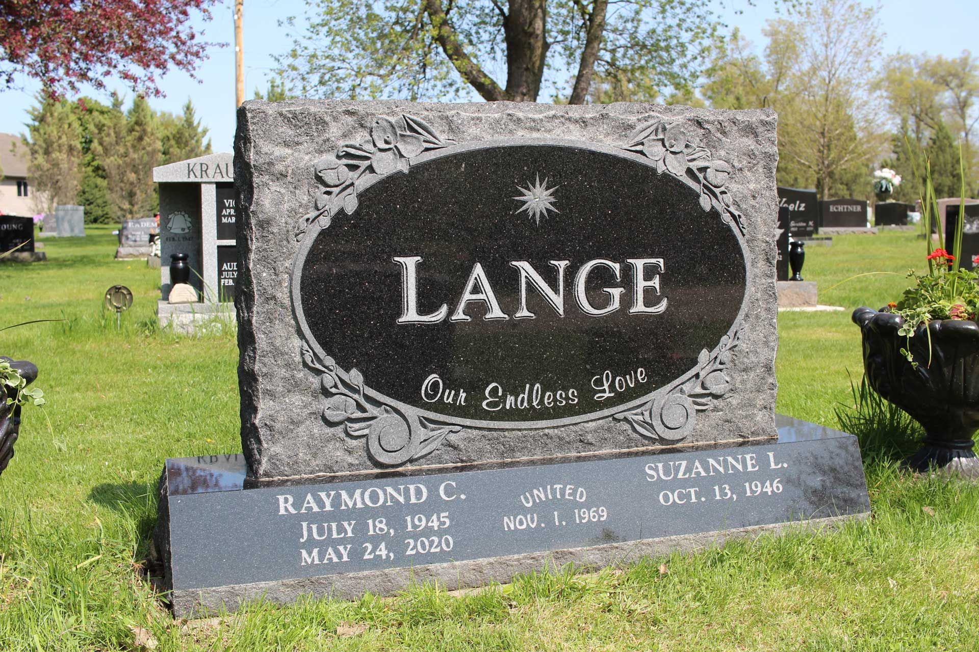 A gravestone for raymond lange in a cemetery