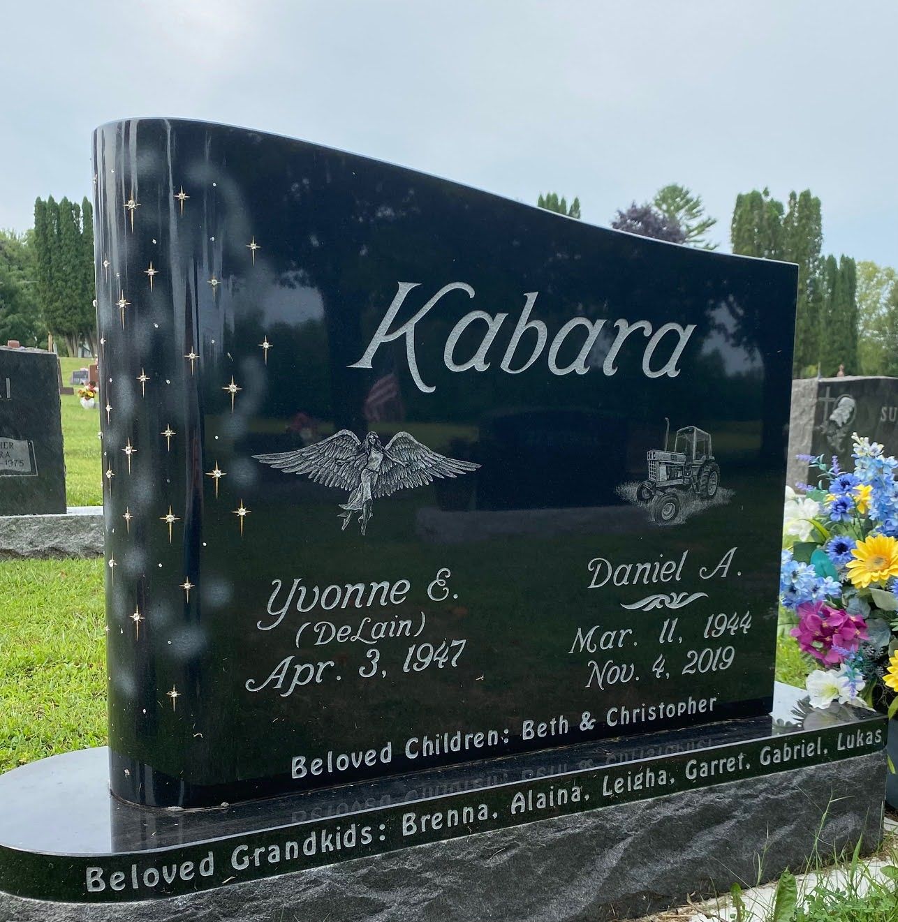 A black book shaped gravestone for kabara in a cemetery