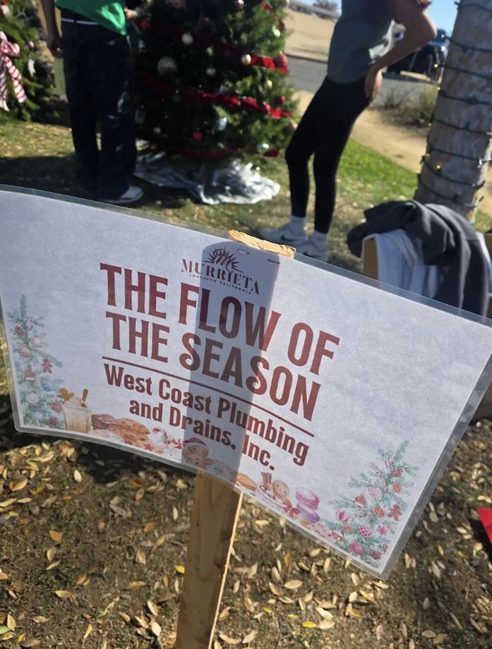 Outdoor lawn sign reads “The Flow of the Season” for West Coast Plumbing and Drains, Inc.
