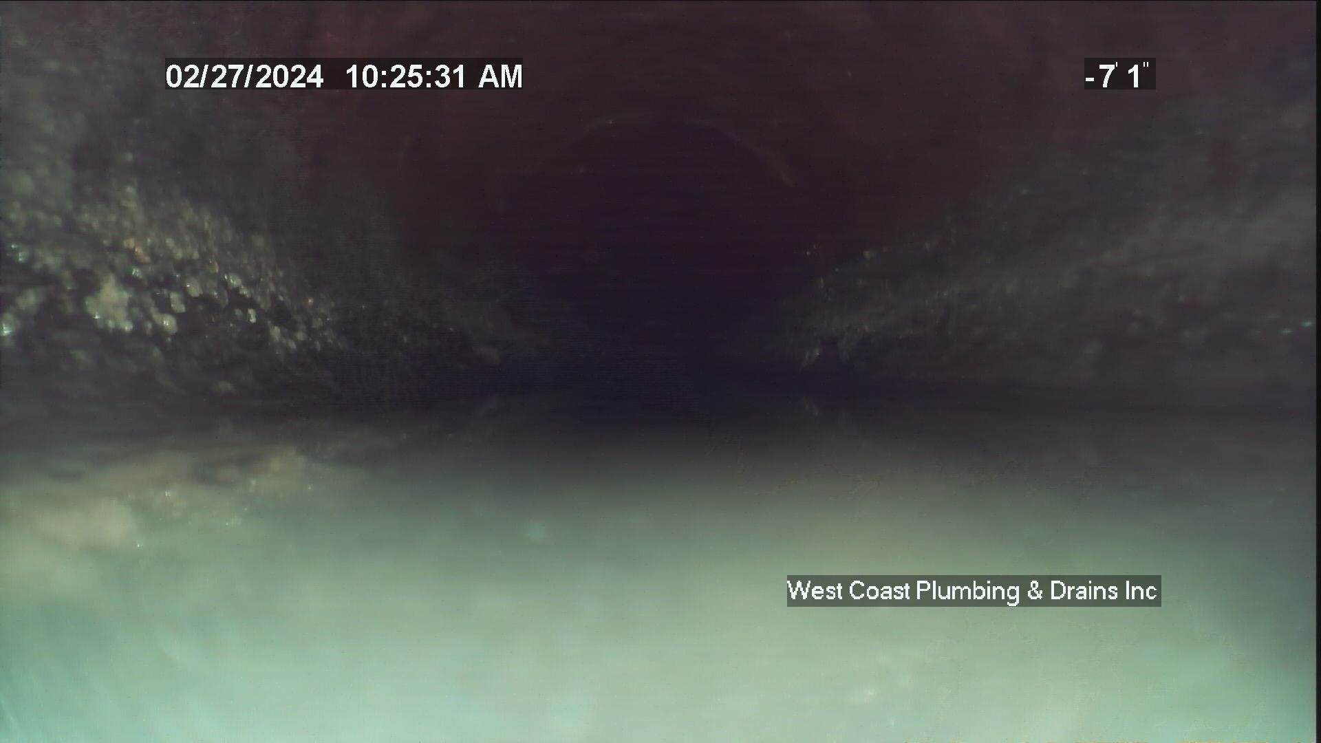 Dark outdoor scene with a faintly lit path or water surface and timestamp text overlay.
