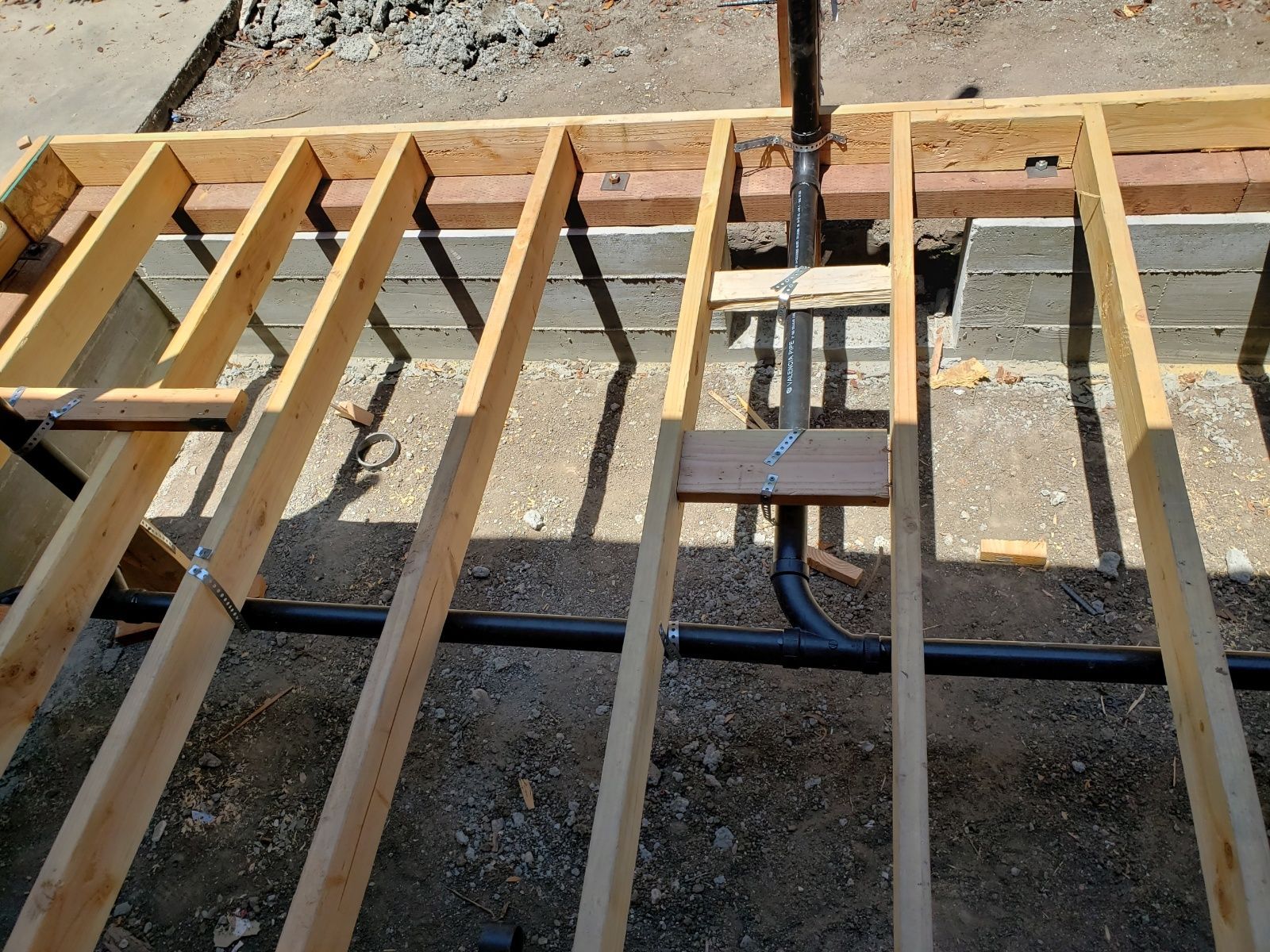 Wooden floor framing with joists over a concrete foundation under construction