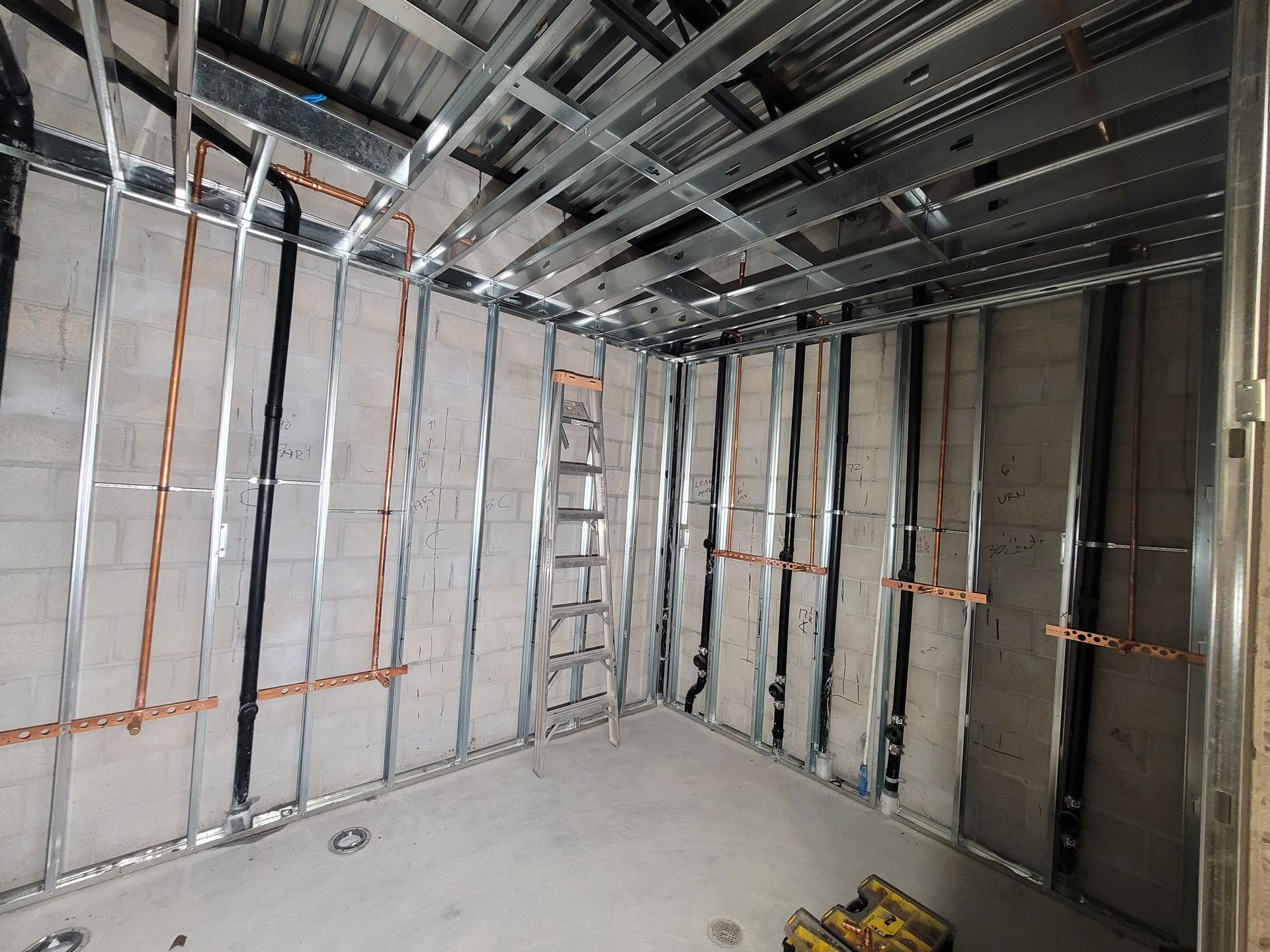 Unfinished room with metal framing, insulation, and concrete floor in a new construction site