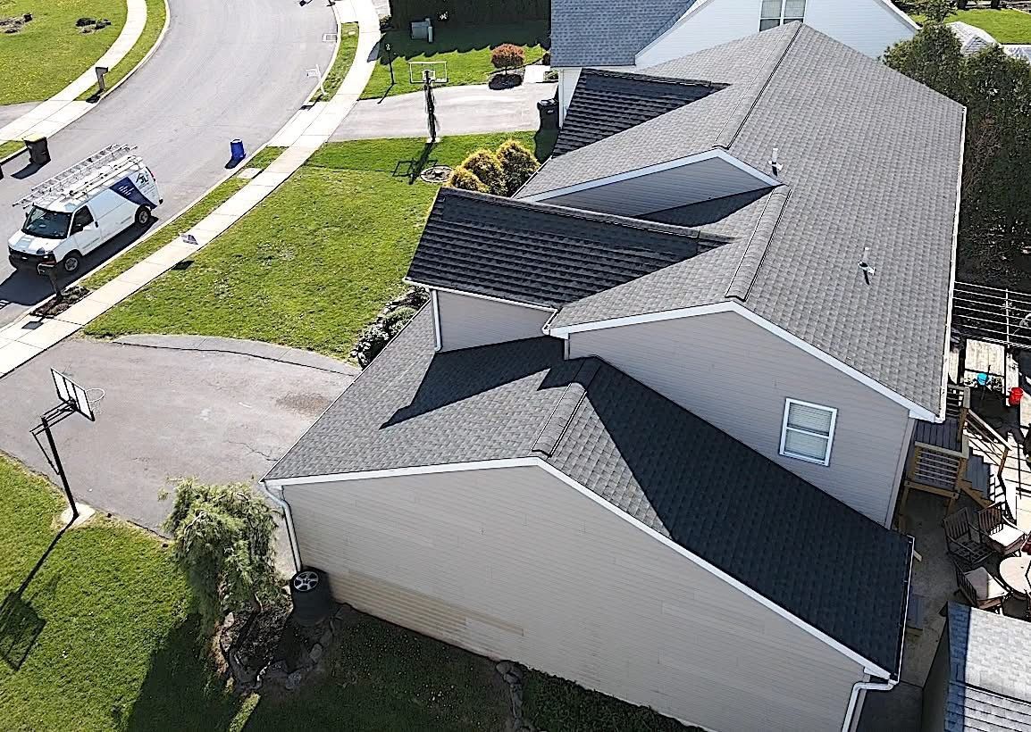 An aerial view of a house with a new roof.