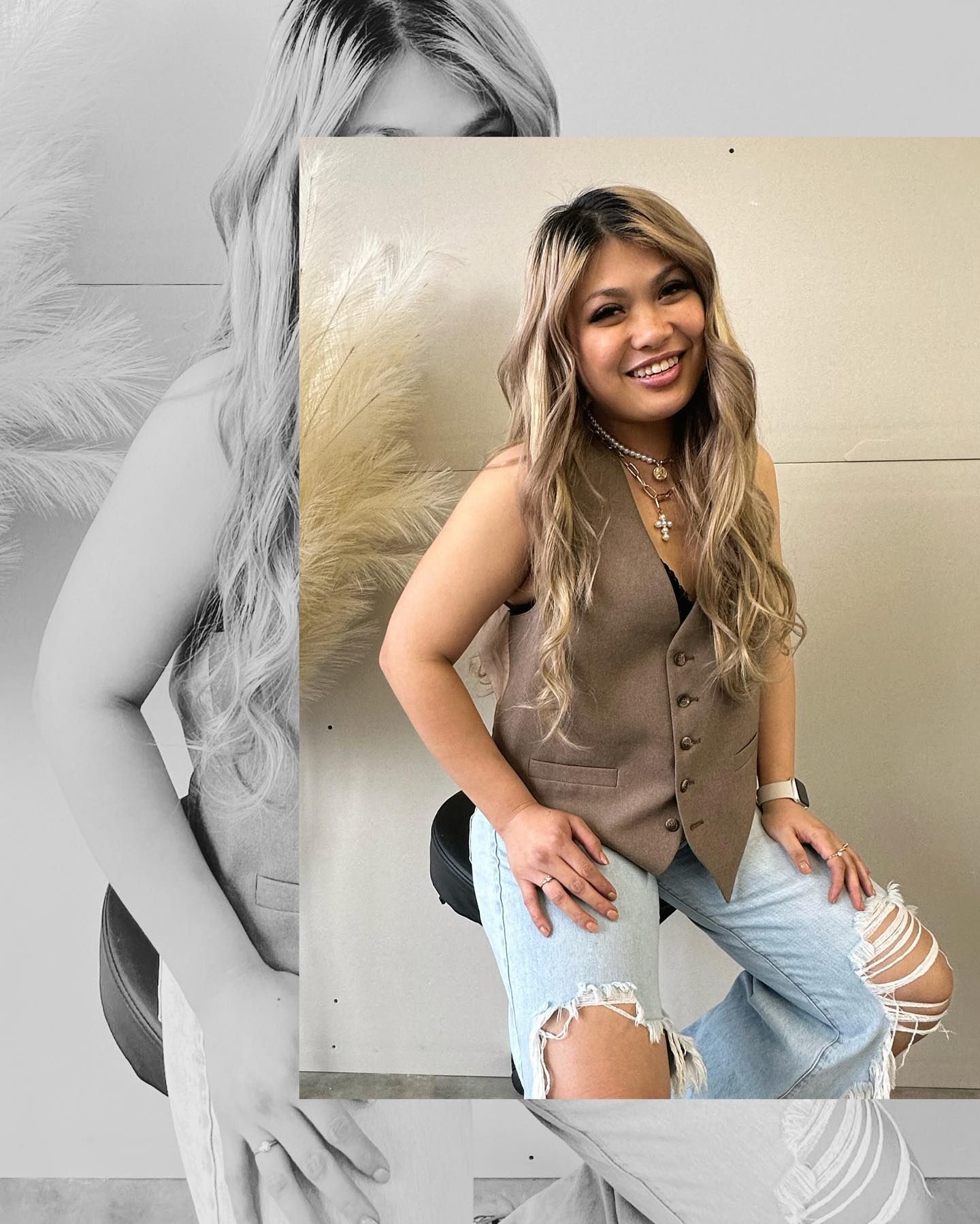 Hairdresser applying product to a client's hair in a salon. Both wear masks and protective gear.