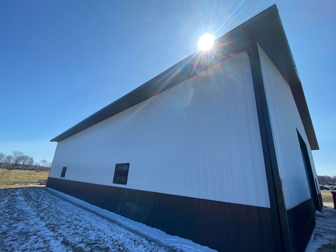 The sun is shining through the windows of a white building.