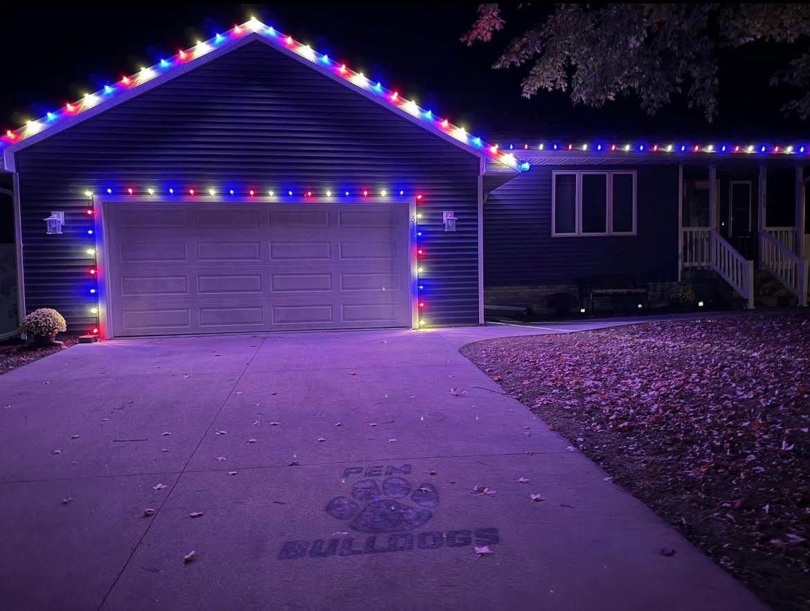 A house with red white and blue Christmas lights on it