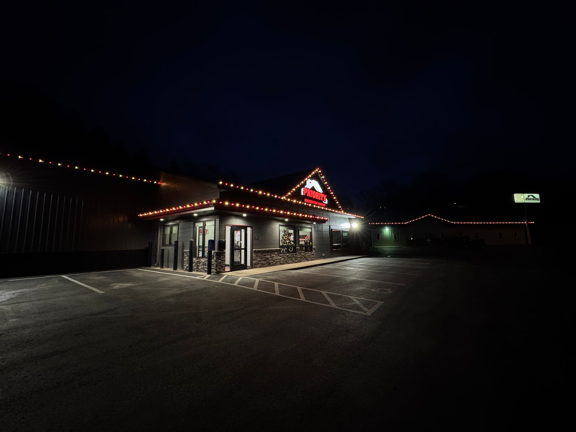 A large building with a lot of lights on it is lit up at night.