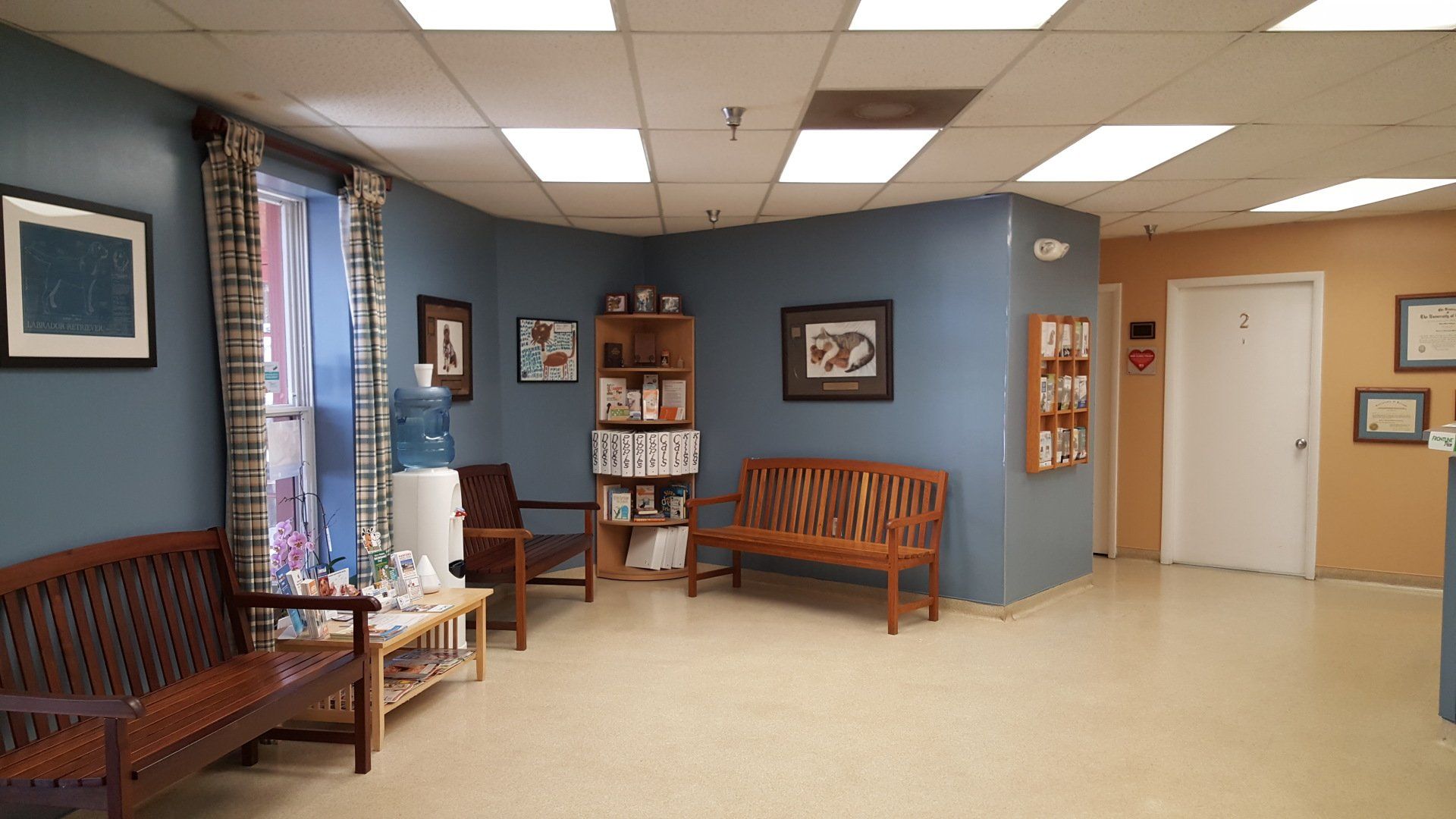 A waiting room with a wooden bench and chairs